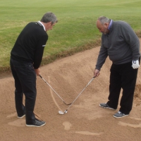 Chubby Chandler gives a bunker lesson at the Sir Ian Botham and Darren Clarke Celebrity Invitational 2012